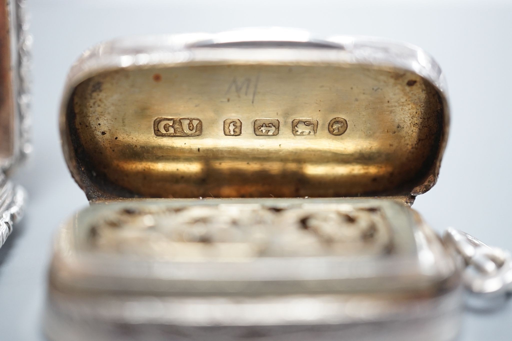 A William IV engraved silver rectangular vinaigrette, with engraved initials, Taylor & Perry, Birmingham, 1833, 42mm and a later oval vinaigrette, by George Unite.